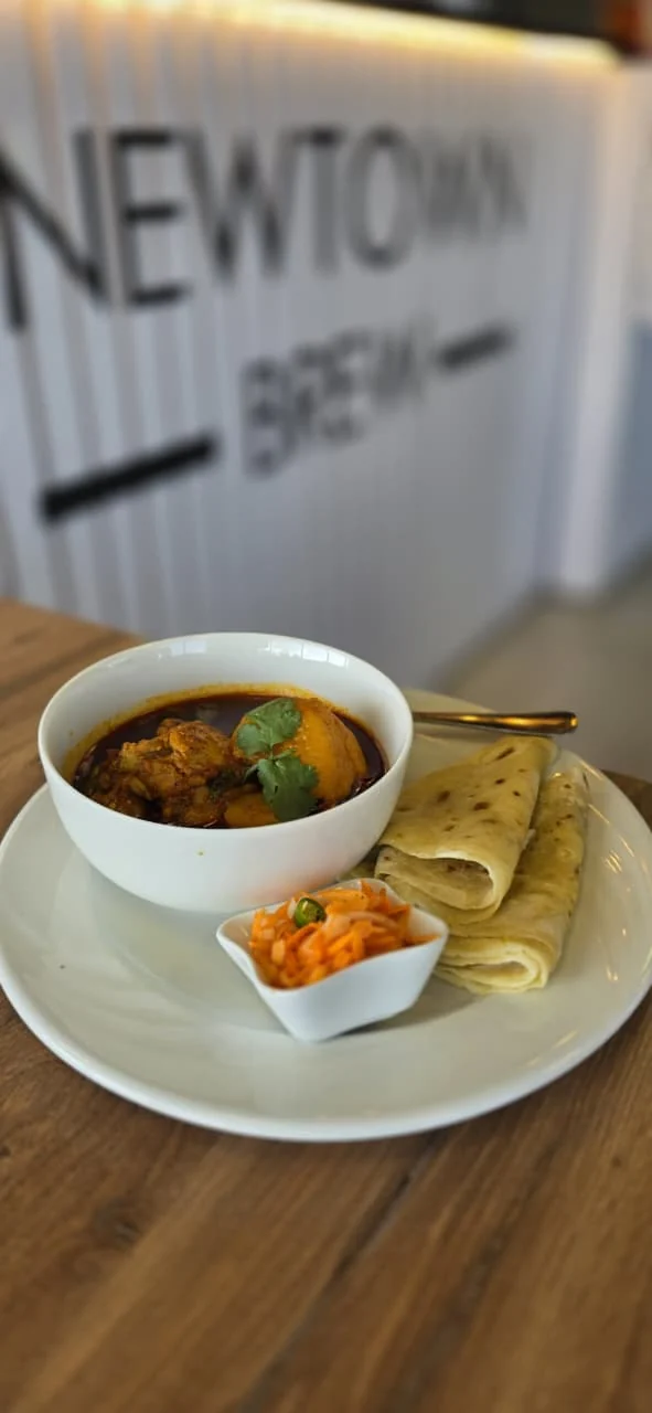 Curry meal with roti served at NewTown Brew